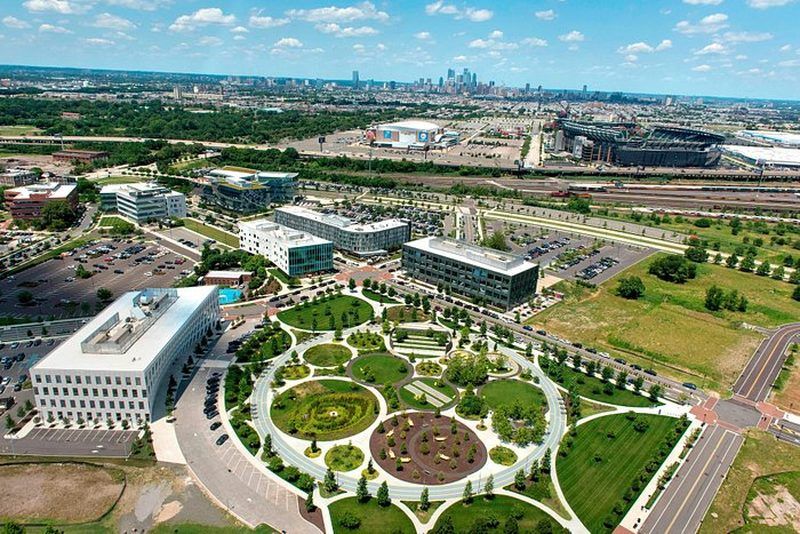 Aerial view of the Navy Yard in South Philadelphia with the Courtyard by Marriott Philadelphia South, the sports complex and the city skyline, host hotel for The Big Dill® Philadelphia 2026 room block on National Pickle Day