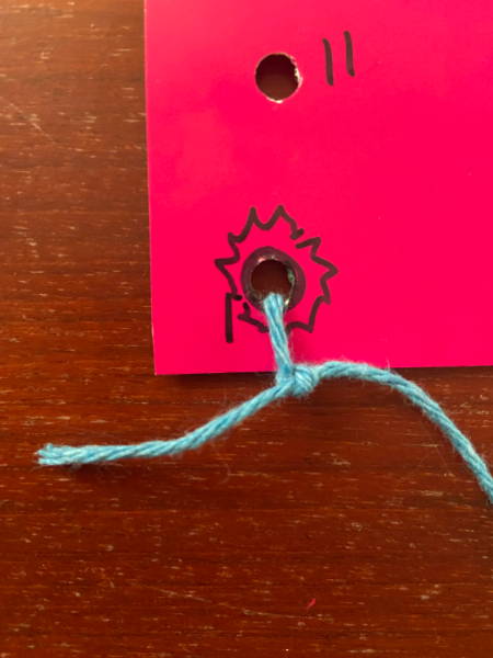 Blue yarn tied to lacing card