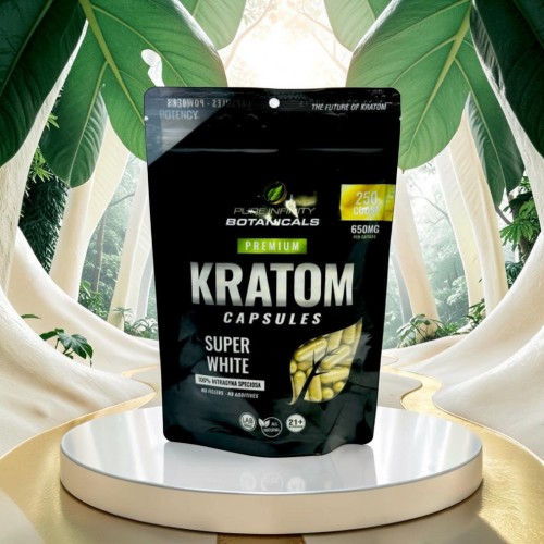 Kratom capsules package on a pedestal surrounded by green leaves.