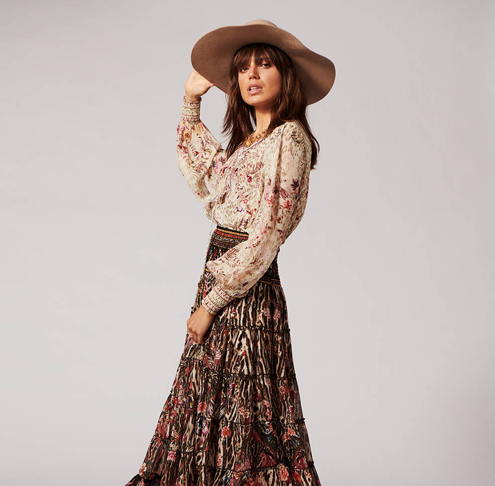 Model wearing CAMILLA cream leopard blouse with dark leopard skirt.