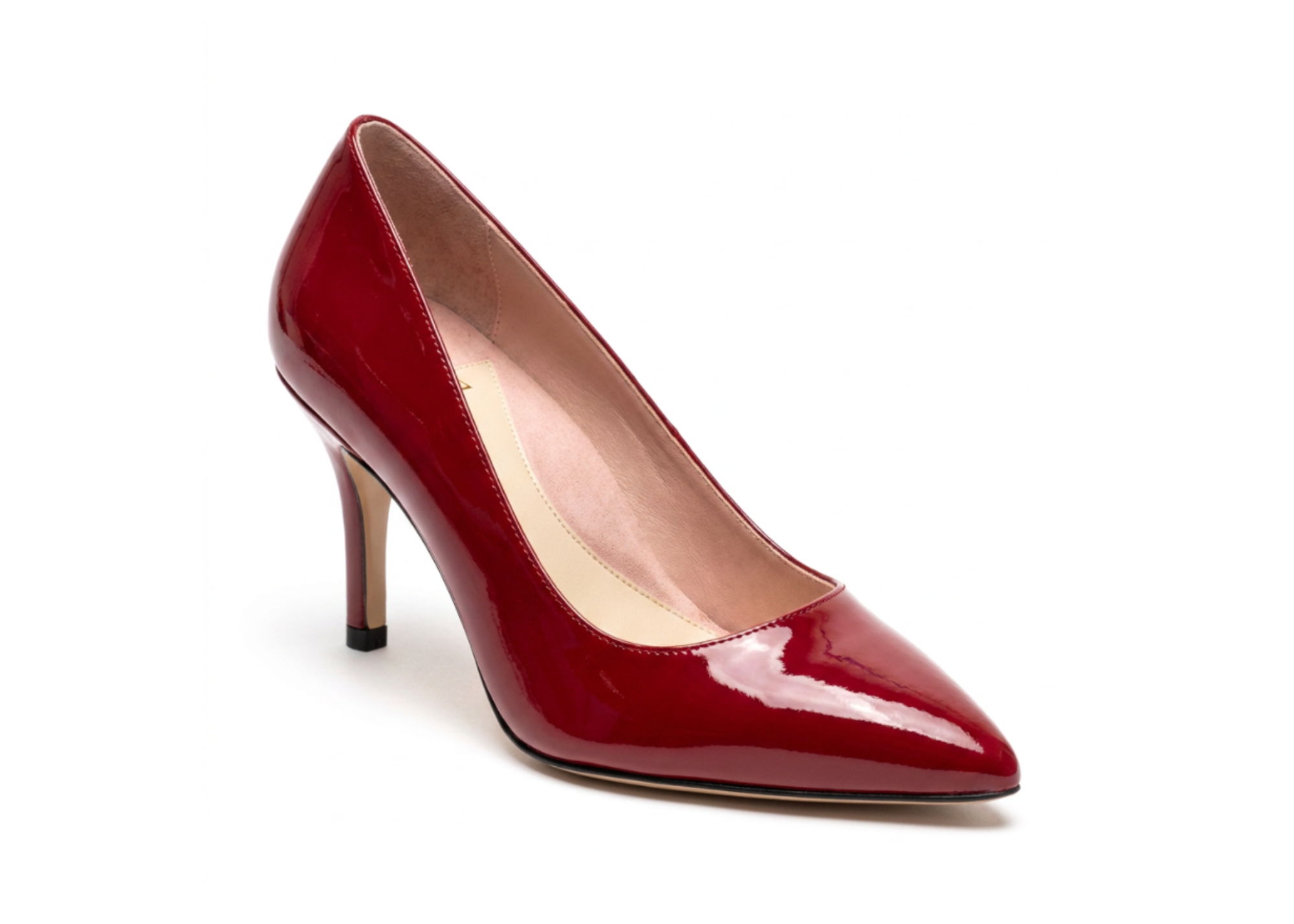 Red patent leather high-heeled shoe with a pointed toe.