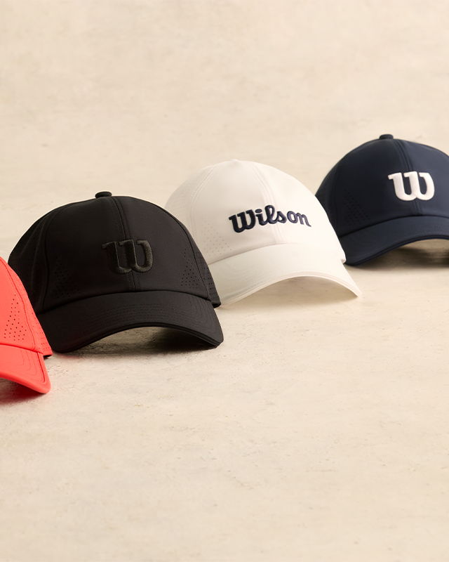 Five baseball caps in various colors displayed in a row.