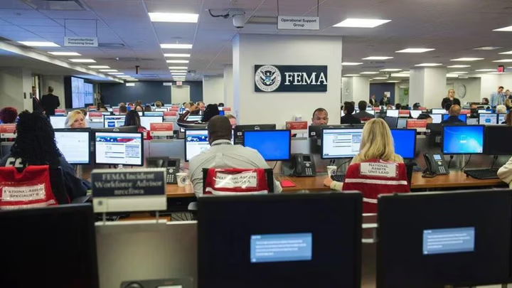 People working at desks in a FEMA office.