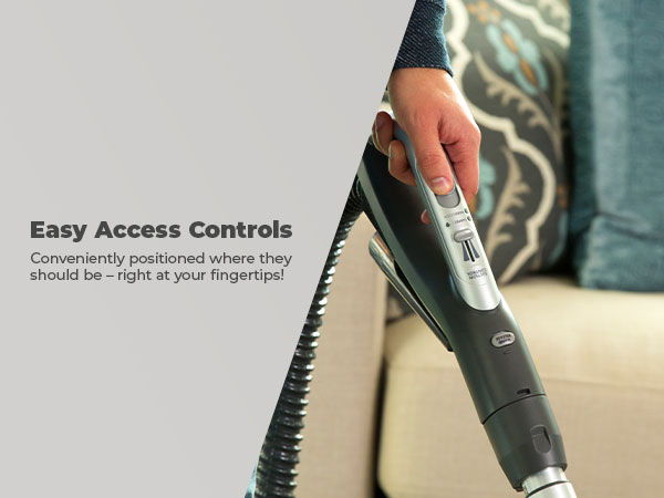 Hand holding a vacuum cleaner with easy access controls.