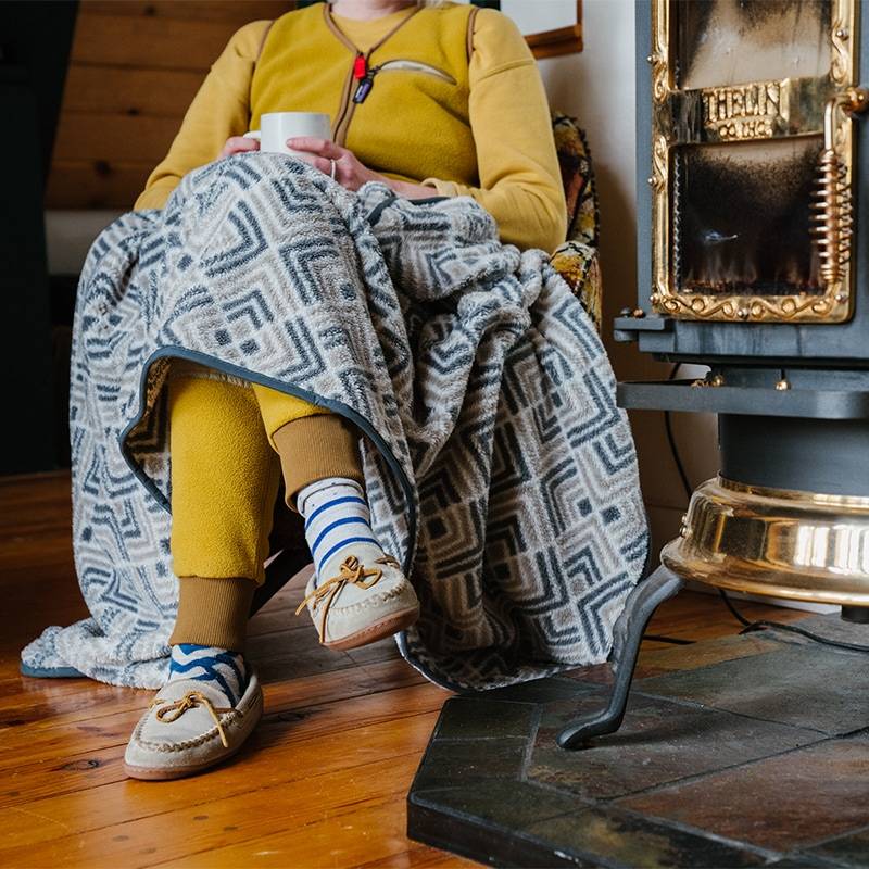 Woman sitting on chair wrapped in Sherpa Fleece Blanket