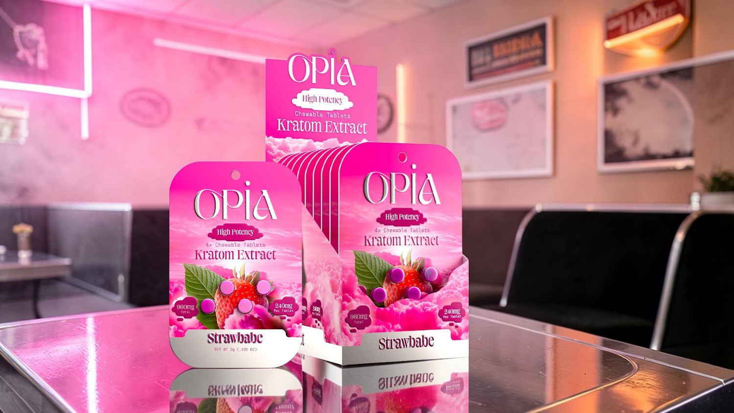 Three pink packaging boxes of a product on a glass table.