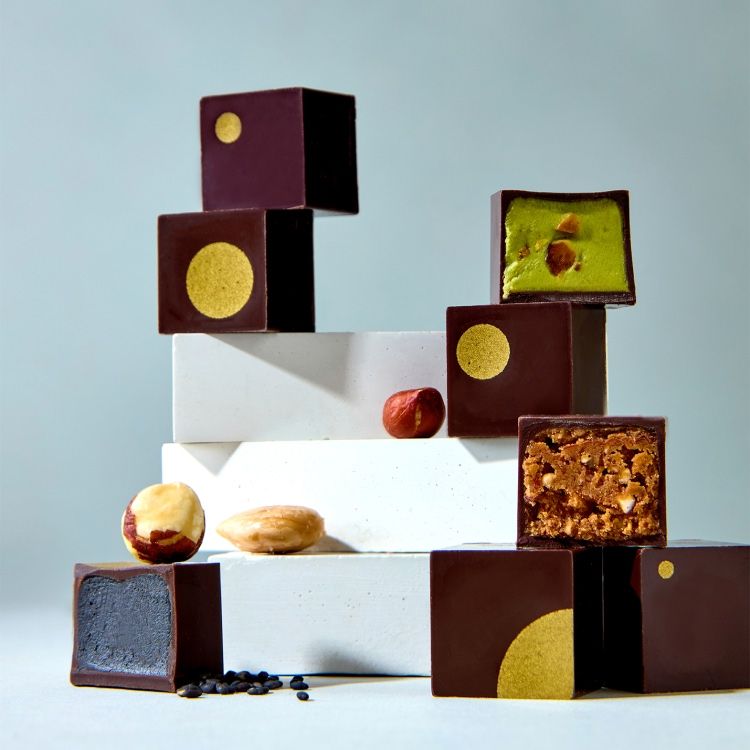 Assorted chocolates and confections arranged artistically on a light background.