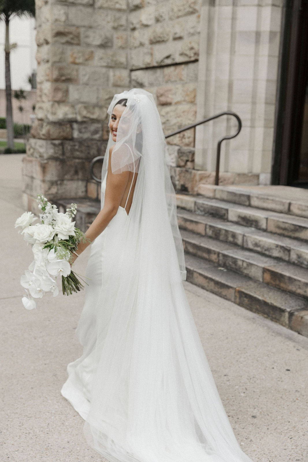 Bride holding bouquet in Grace Loves Lace Summer Gown