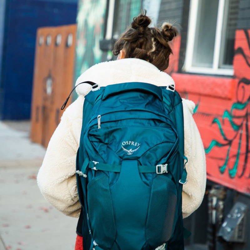 Woman wearing osprey Fairview 40 travel backpack.