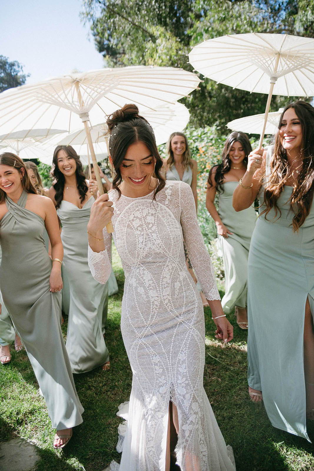 Bride and her bridesmaids dressed in sage green