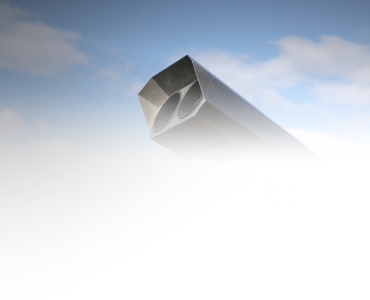 A metallic object with a hexagonal opening against a cloudy sky background.