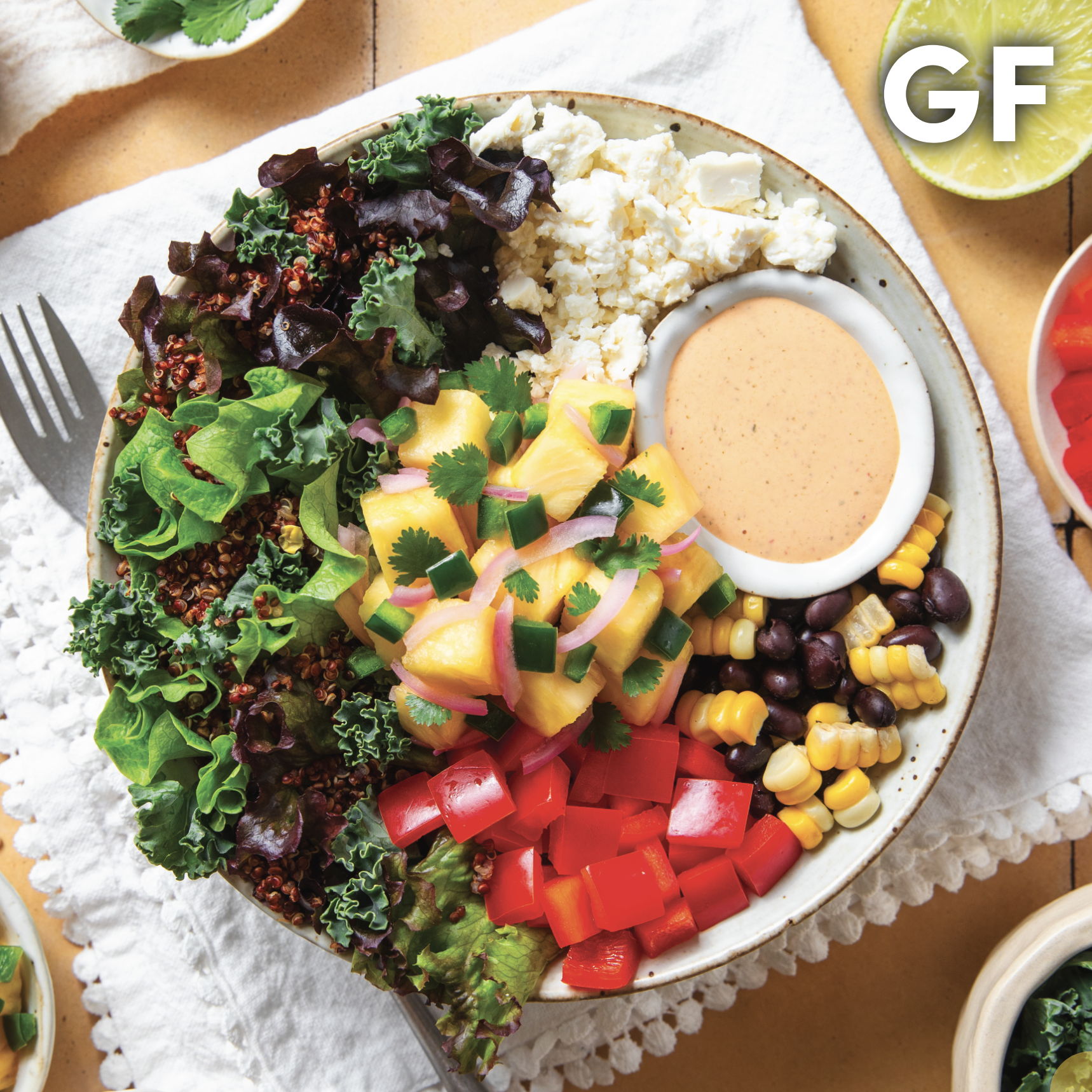 Colorful salad bowl with greens, beans, corn, and dressing. Gluten-free label.