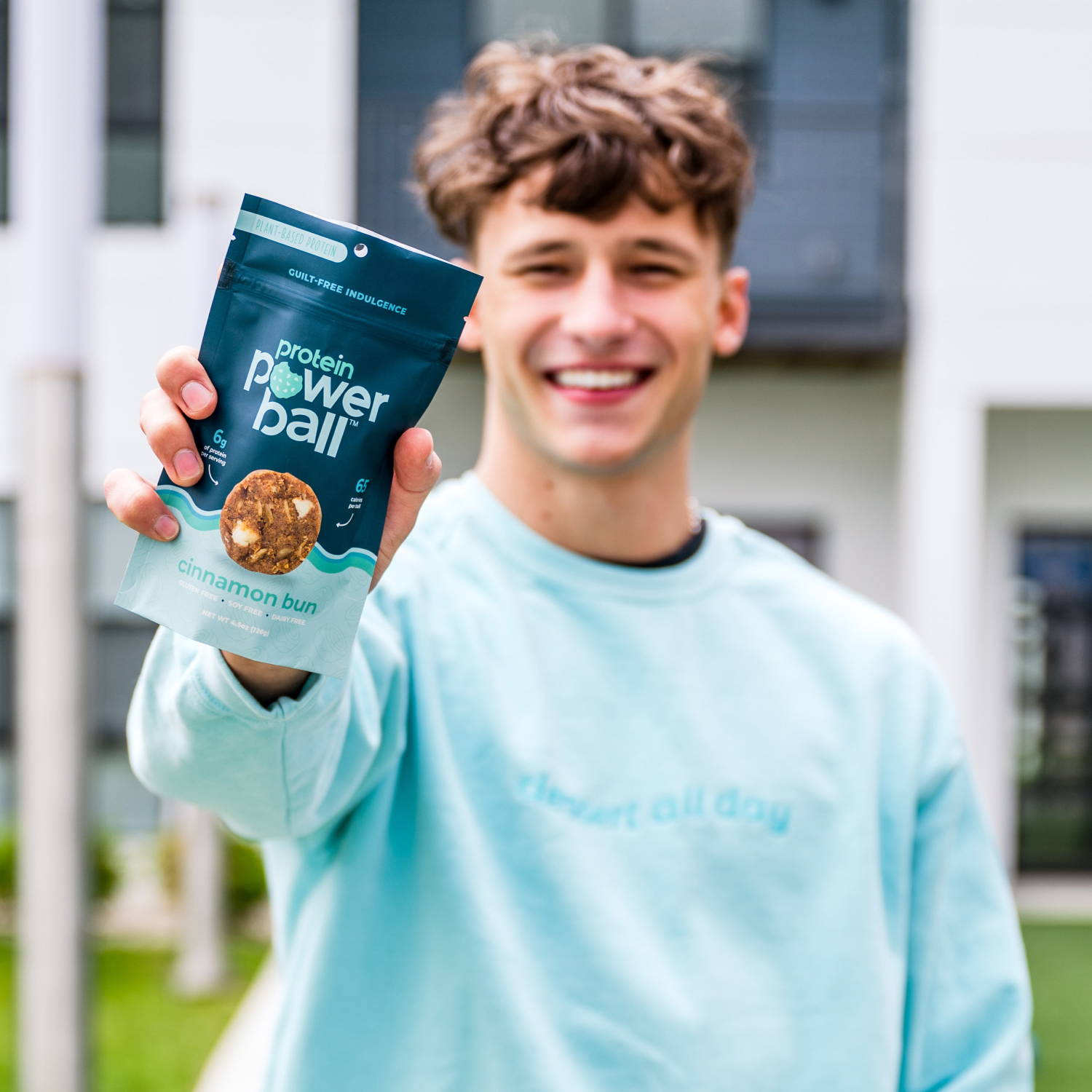Male holding Protein Powerball