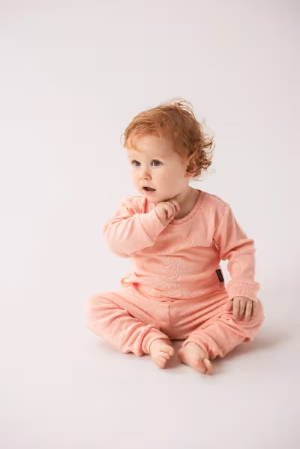 Toddler sitting wearing cotton rib pyjamas