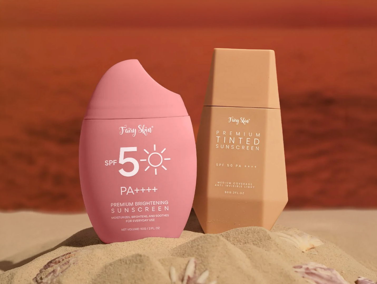 Two sunscreen products on a sandy surface with a red background.