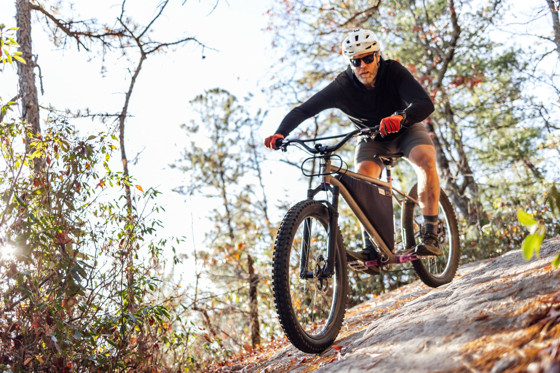 Person riding a mountain bike on a wooded trail. The Esker Cycles Hayduke LVS in Pisgah National Forest