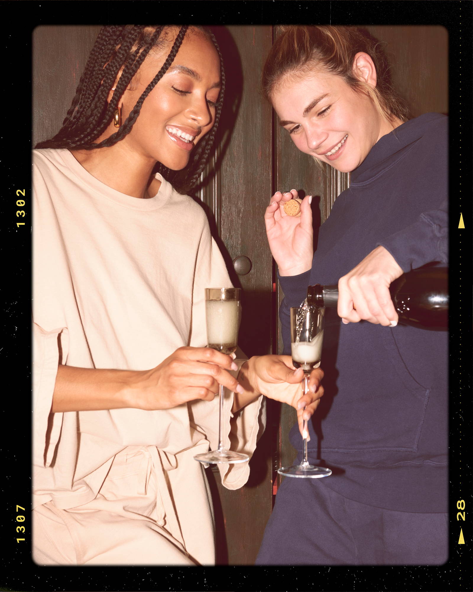 models pouring champaign in core clothing