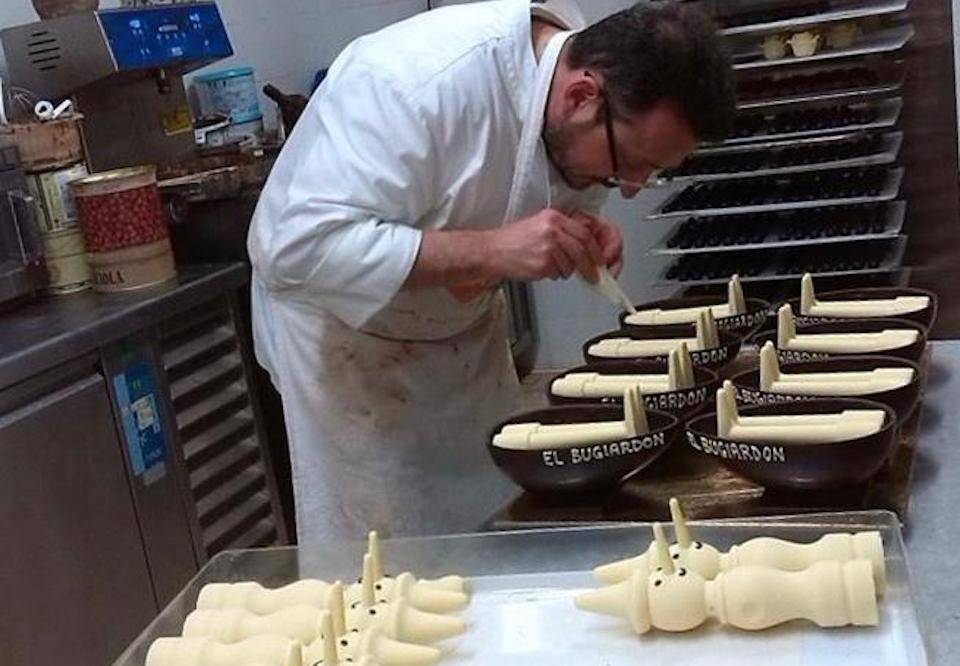 An artisan chocolatier makes edible figures