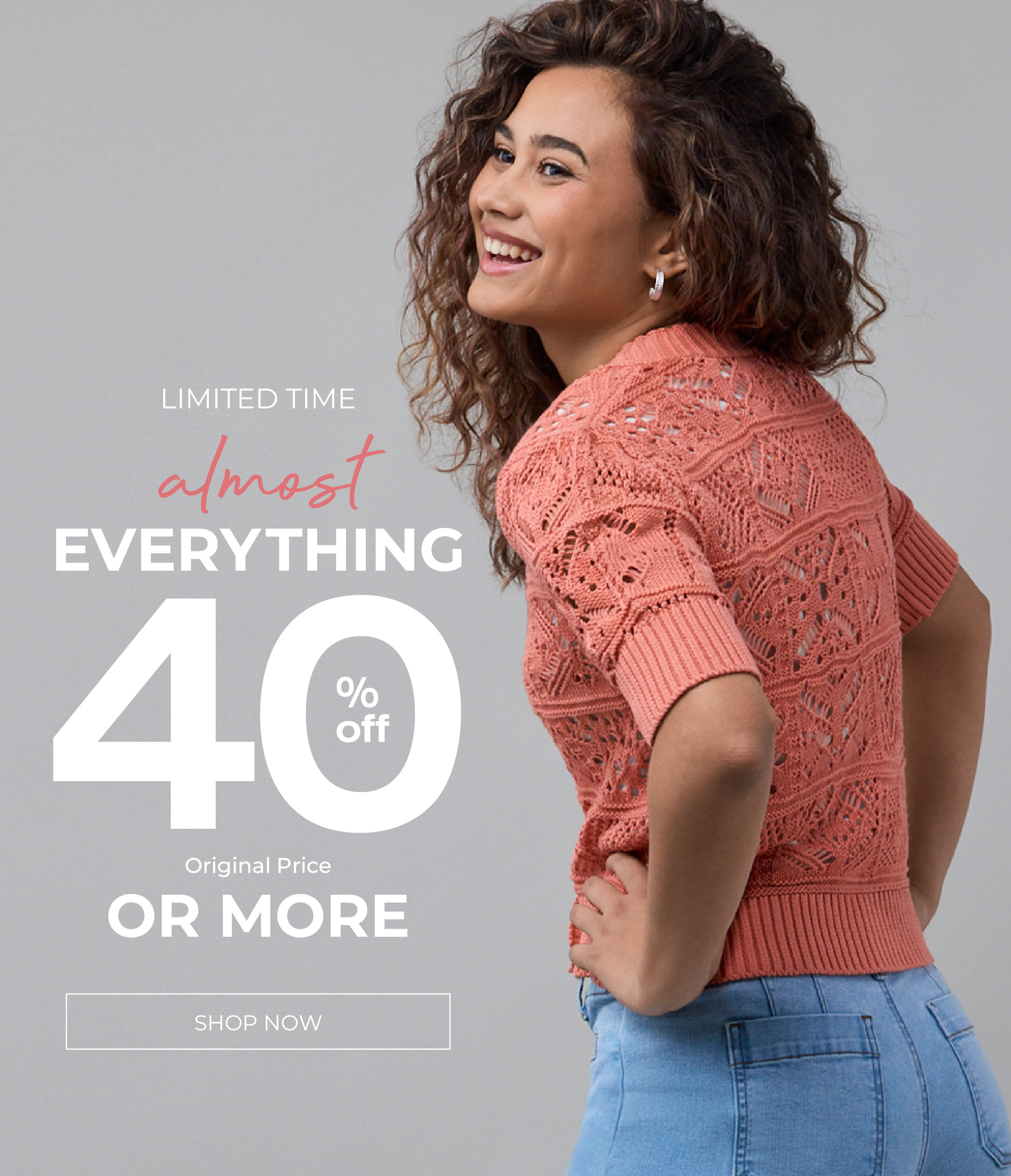 Smiling woman in a coral sweater promoting almost everything 40% off or more.