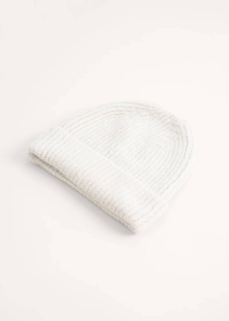 An off white knitted beanie hat