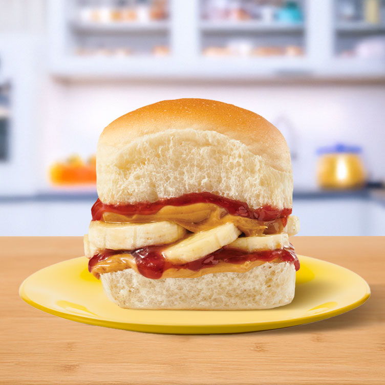 A sandwich with peanut butter and jelly on a yellow plate.