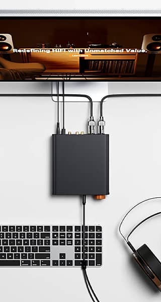 Audio interface connected to a keyboard and headphones, with a screen above.