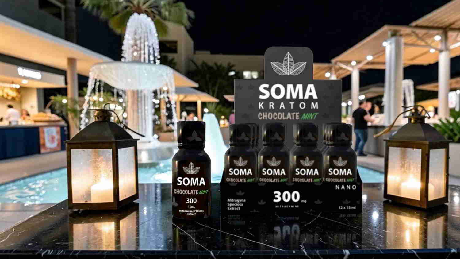 Bottles of SOMA brand products displayed near a fountain at night.