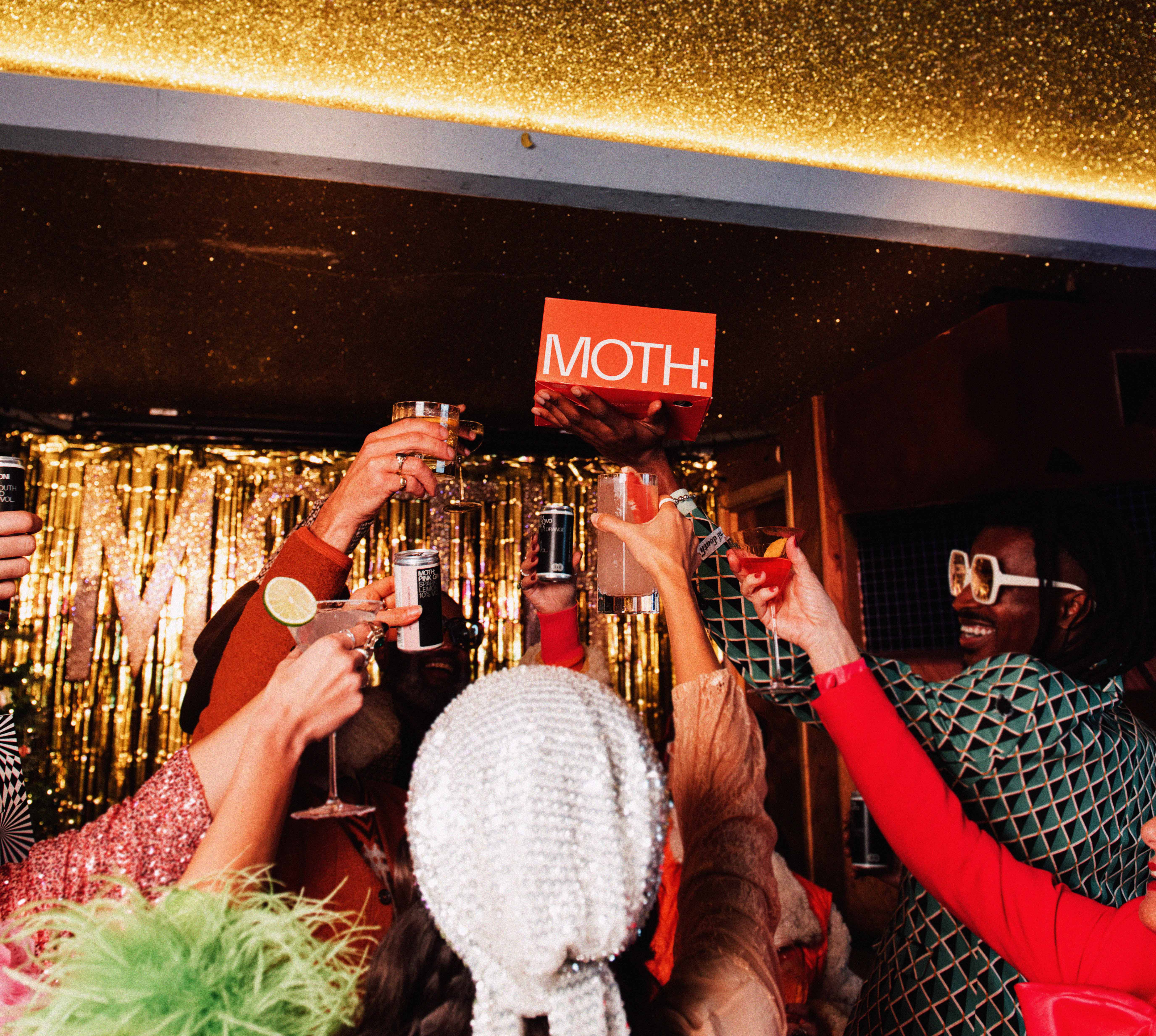 People toasting with drinks at a festive celebration.