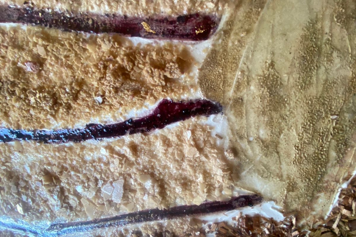 Close-up of textured surface with dark lines and light areas.