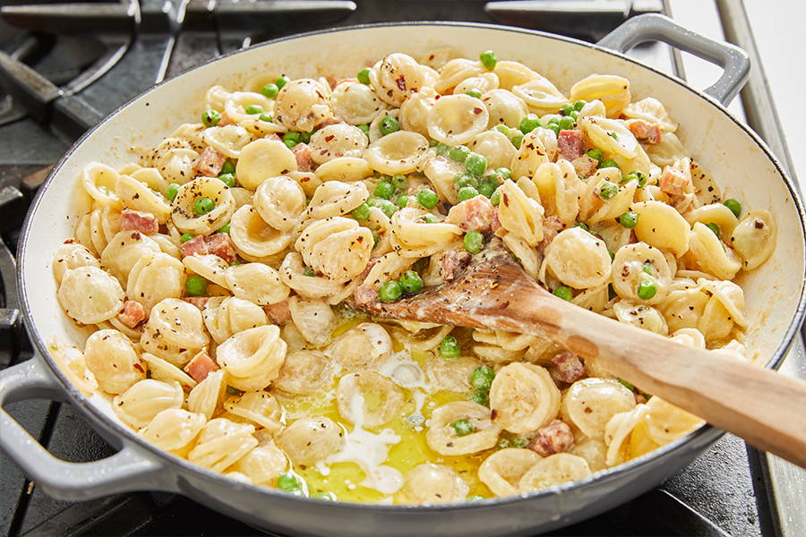 Orecchiette pasta in a creamy sauce with peas and pancetta.