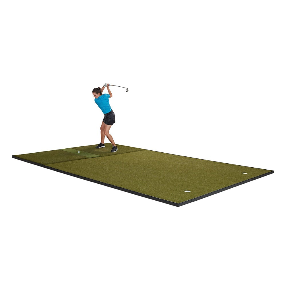 Woman swinging on a Fiberbuilt golf hitting and putting mat
