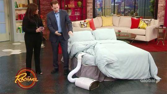 Still from the Rachael Ray show showing the cast interacting with a BedJet