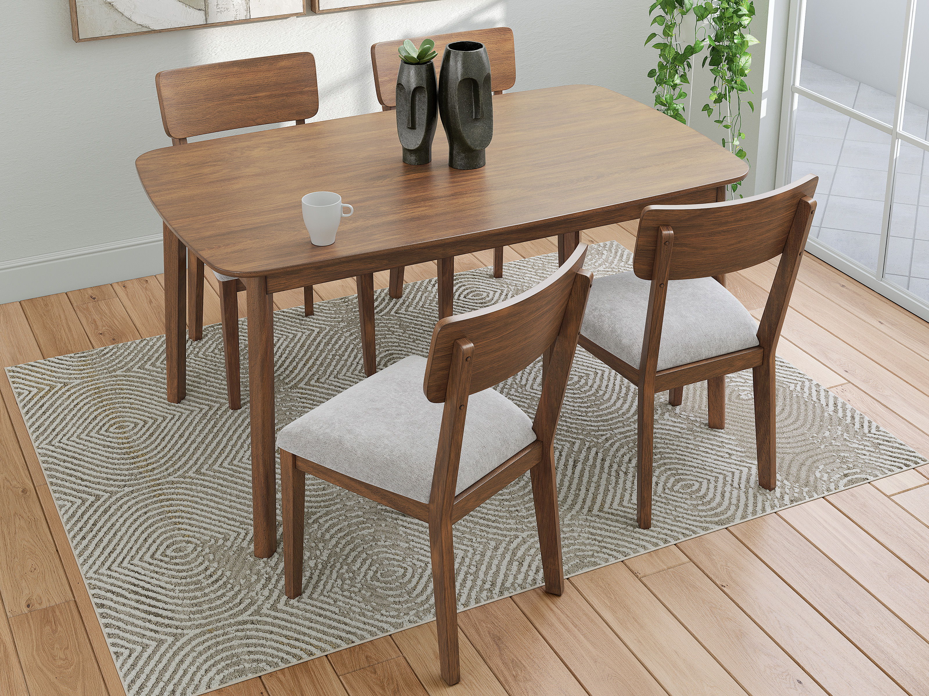 A wooden dining table with four chairs on a rug.