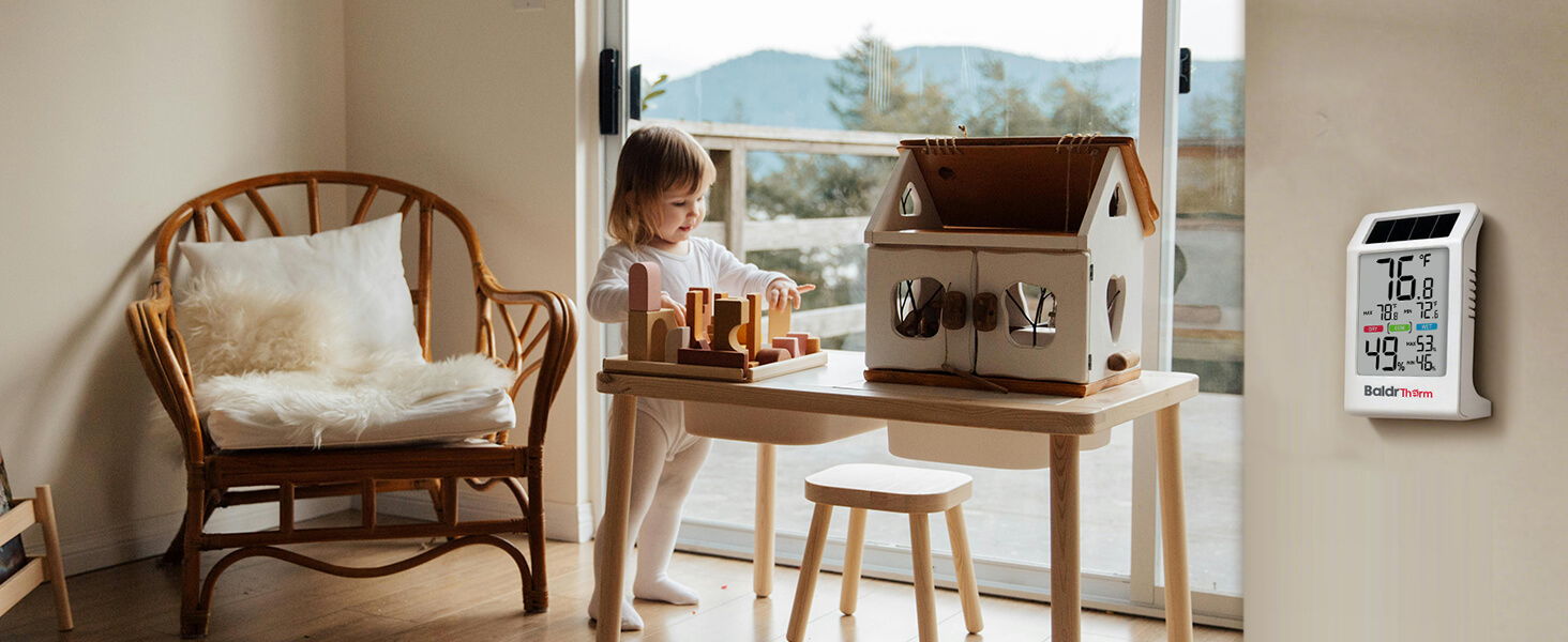 Child playing with a toy house in a cozy indoor setting.