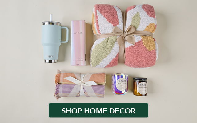 Home decor items including towels, a mug, and candles.