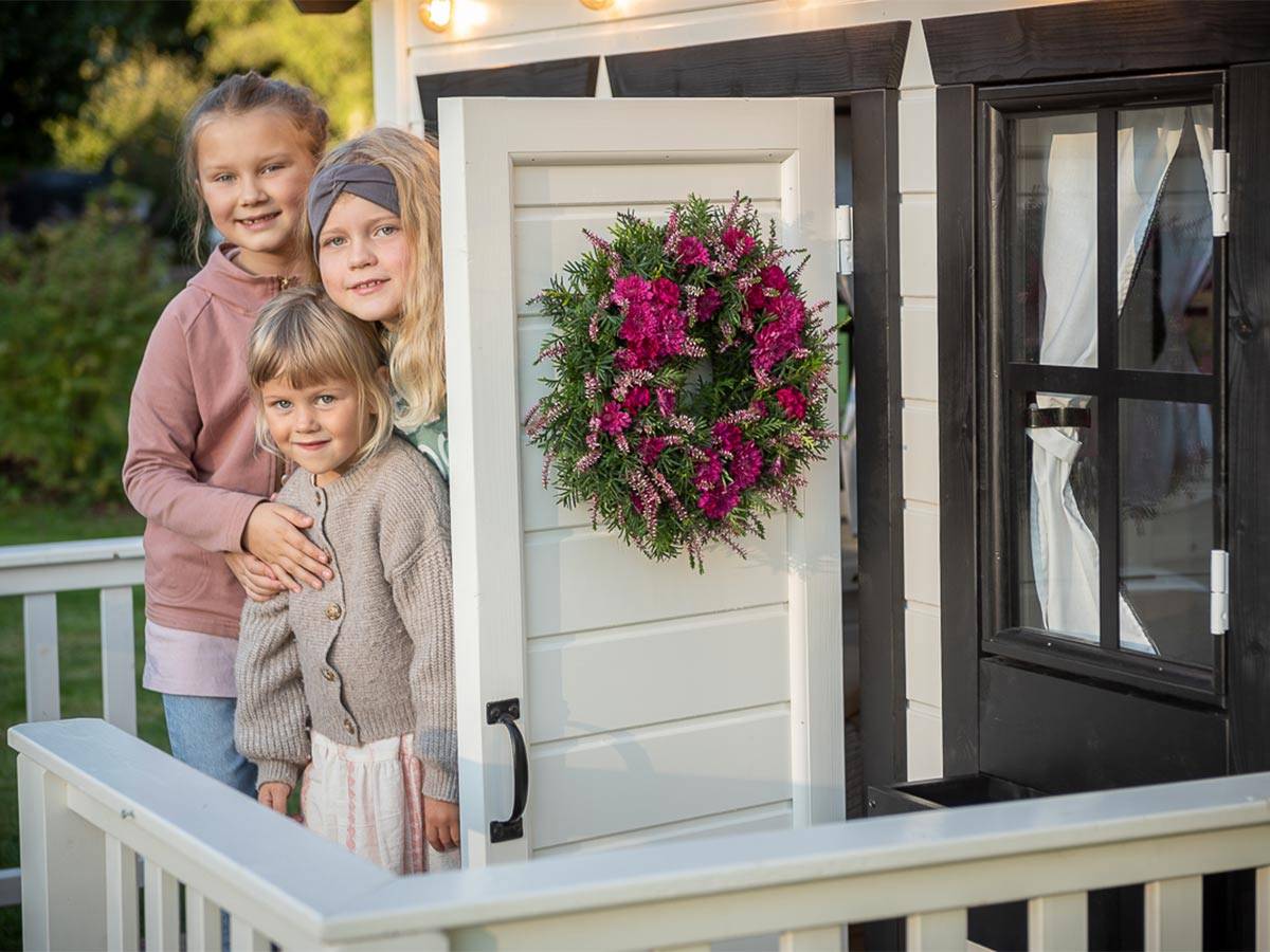 Kids Playing outside of  Black and White Wooden Playhouse Blackbird by WholeWoodPlayhouses