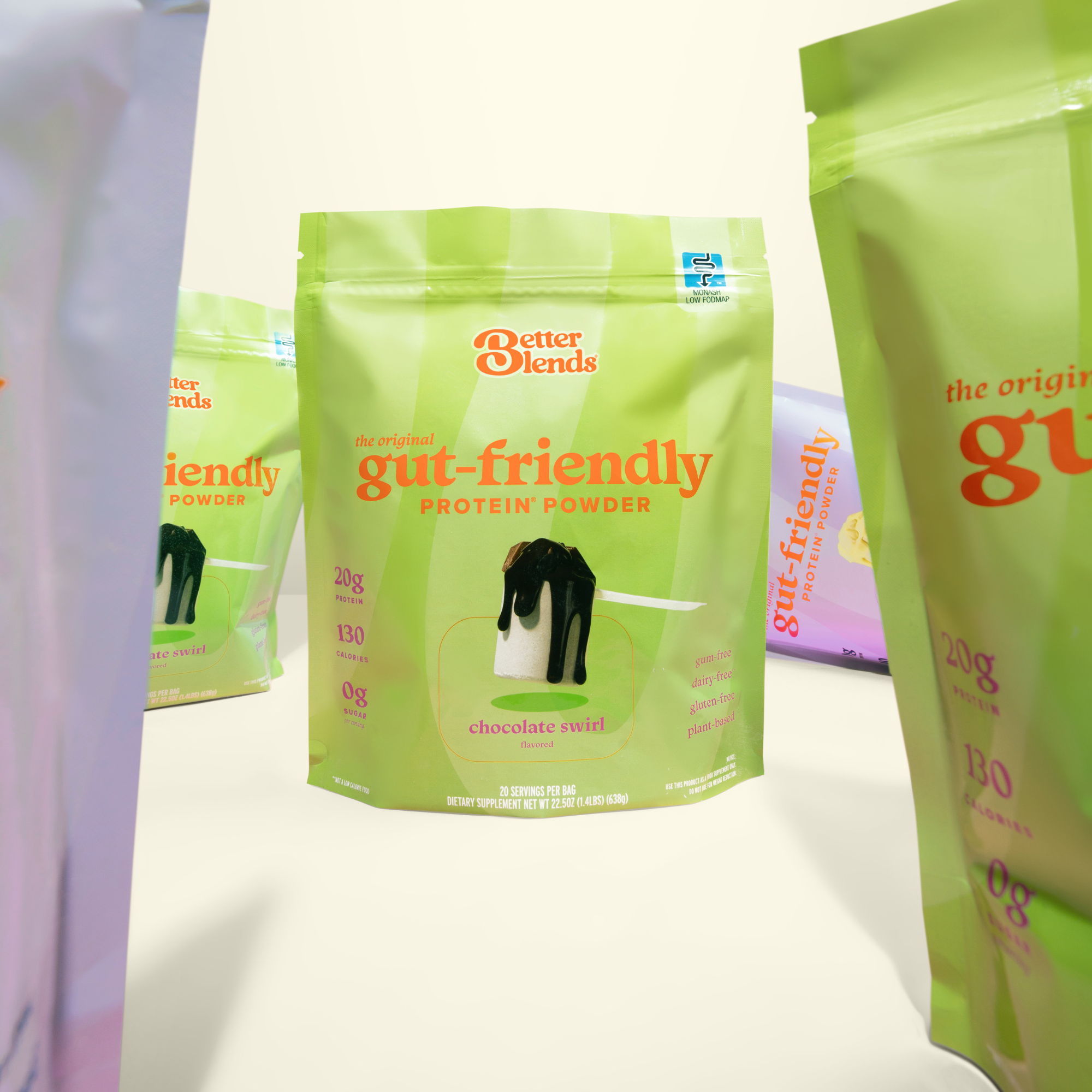 Better Blends Chocolate Swirl gut-friendly protein powder bag displayed among green and lavender product packaging.
