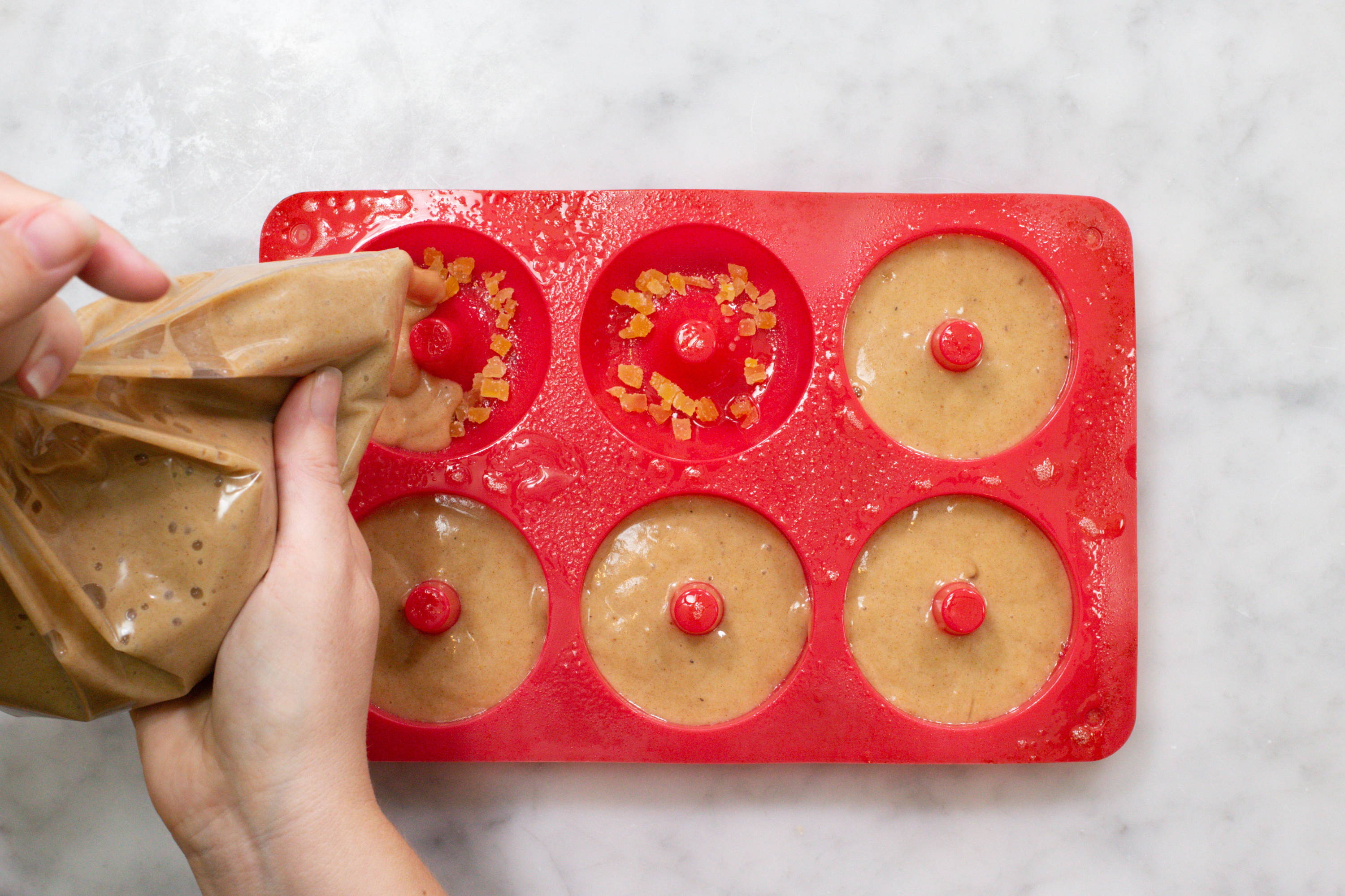 Adding batter to doughnut pan