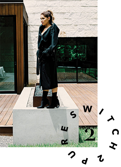 Estela Cockrell, Founder of Switch2Pure, wearing black coat and black booties. 