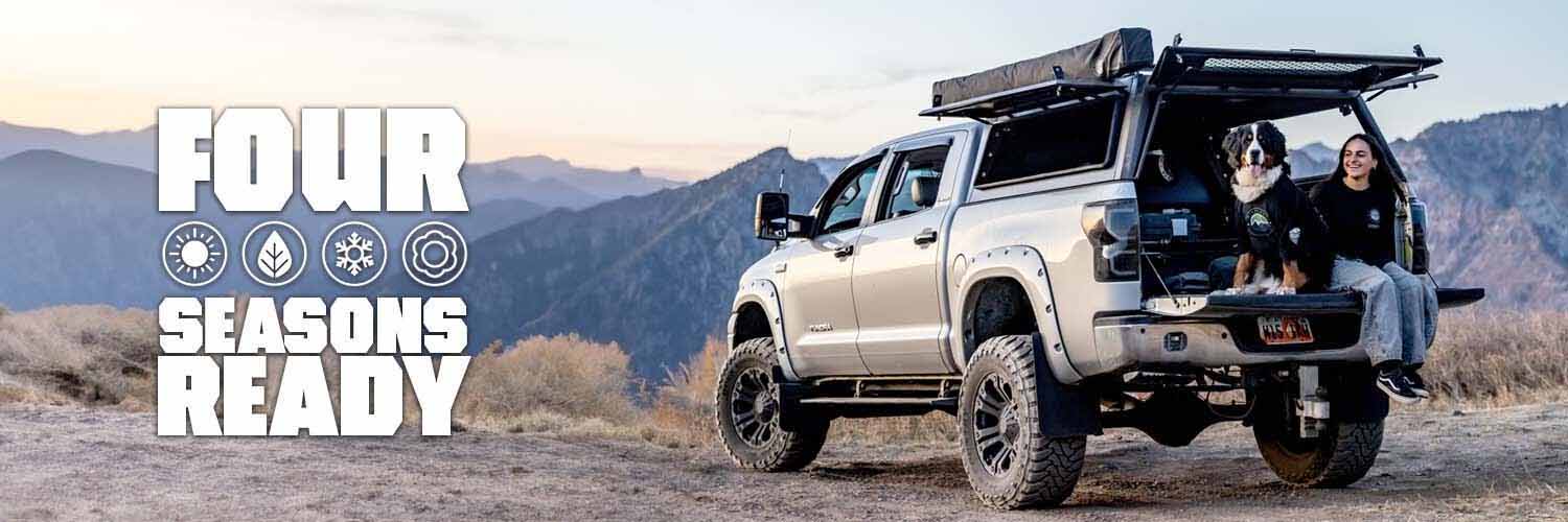 A truck in a scenic outdoor setting, promoting four seasons readiness.