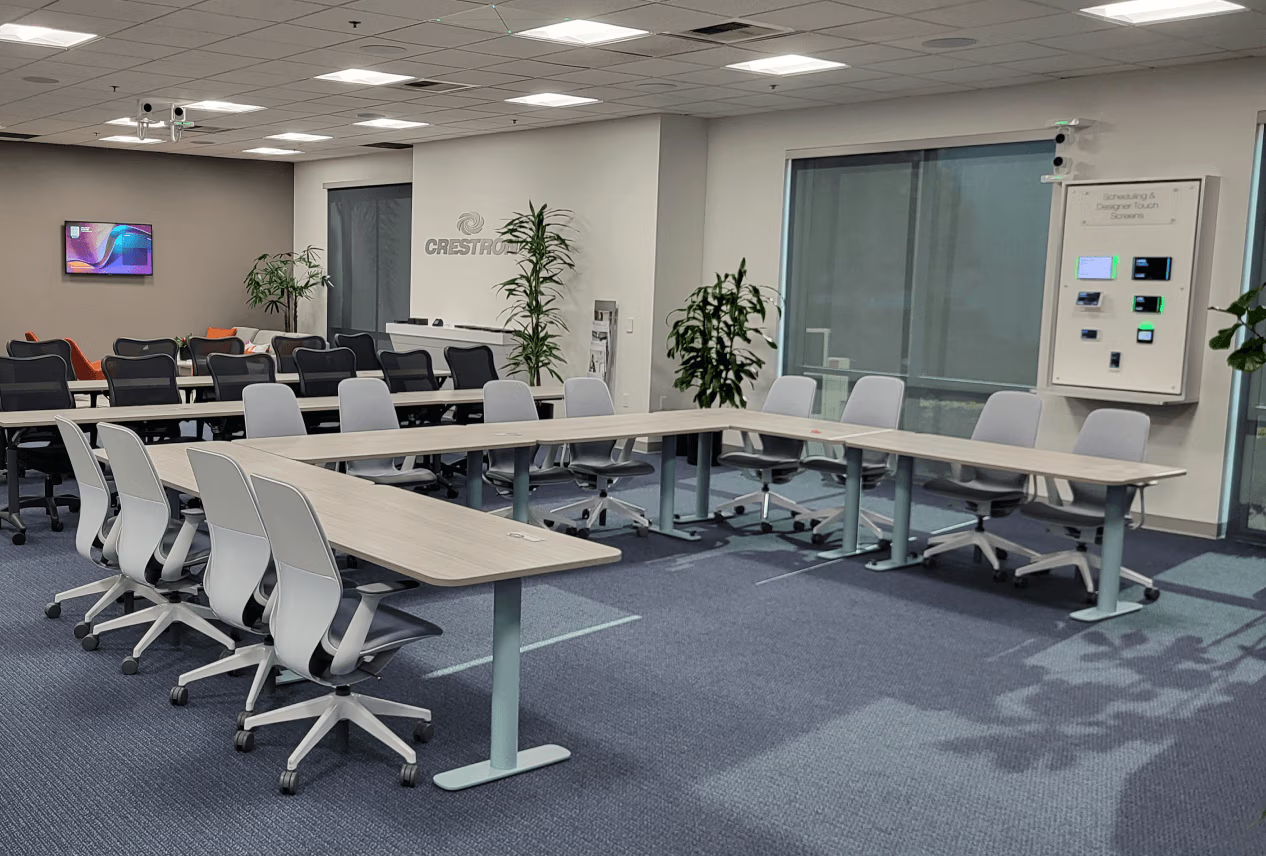 Modern conference room with a large table, chairs, and windows.