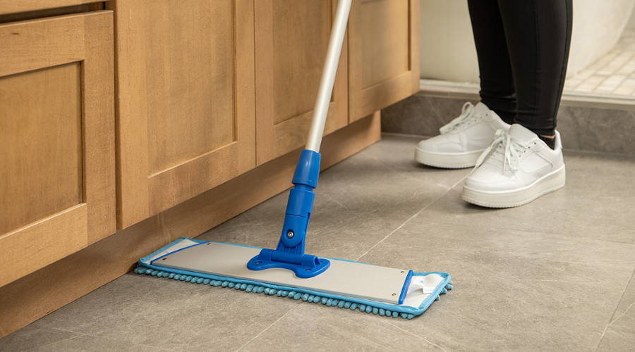 person cleaning floor with microfiber mop