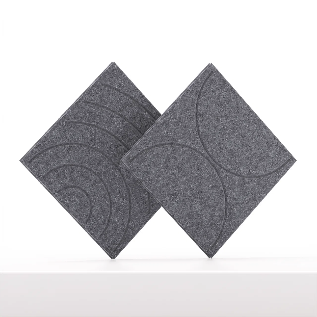 Two dark gray ofinto Cubox soft felt panels with different embossed design grooves, displayed standing on their tips against a white background.