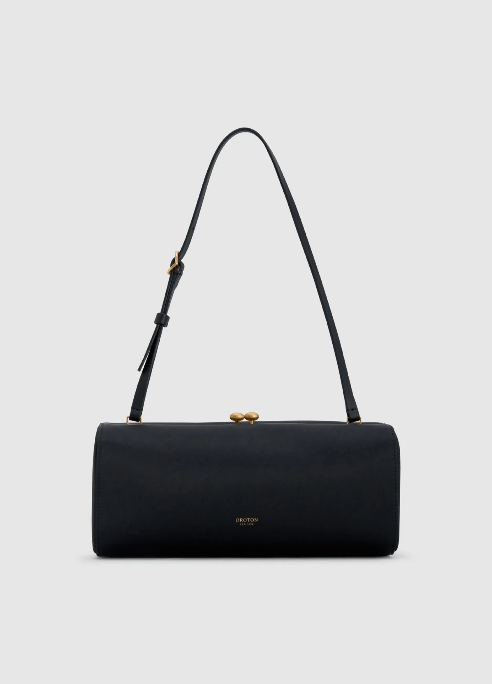 Black handbag with a gold clasp and adjustable strap.
