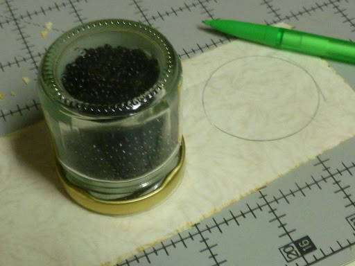 Round object being used to trace around and make circles onto fusible web