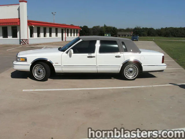 Side profile of 1996 Lincoln Town Car with Conductor's Special 228H train horn kit install HornBlasters gallery photo 2