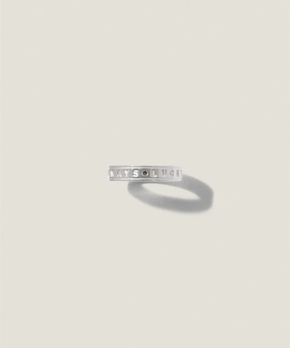 A simple silver ring casting a shadow on a light background.