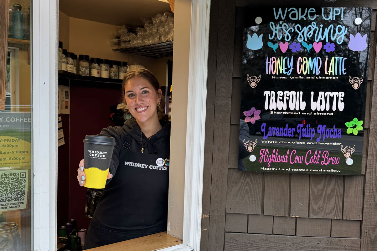 Barista holding a cup of coffee