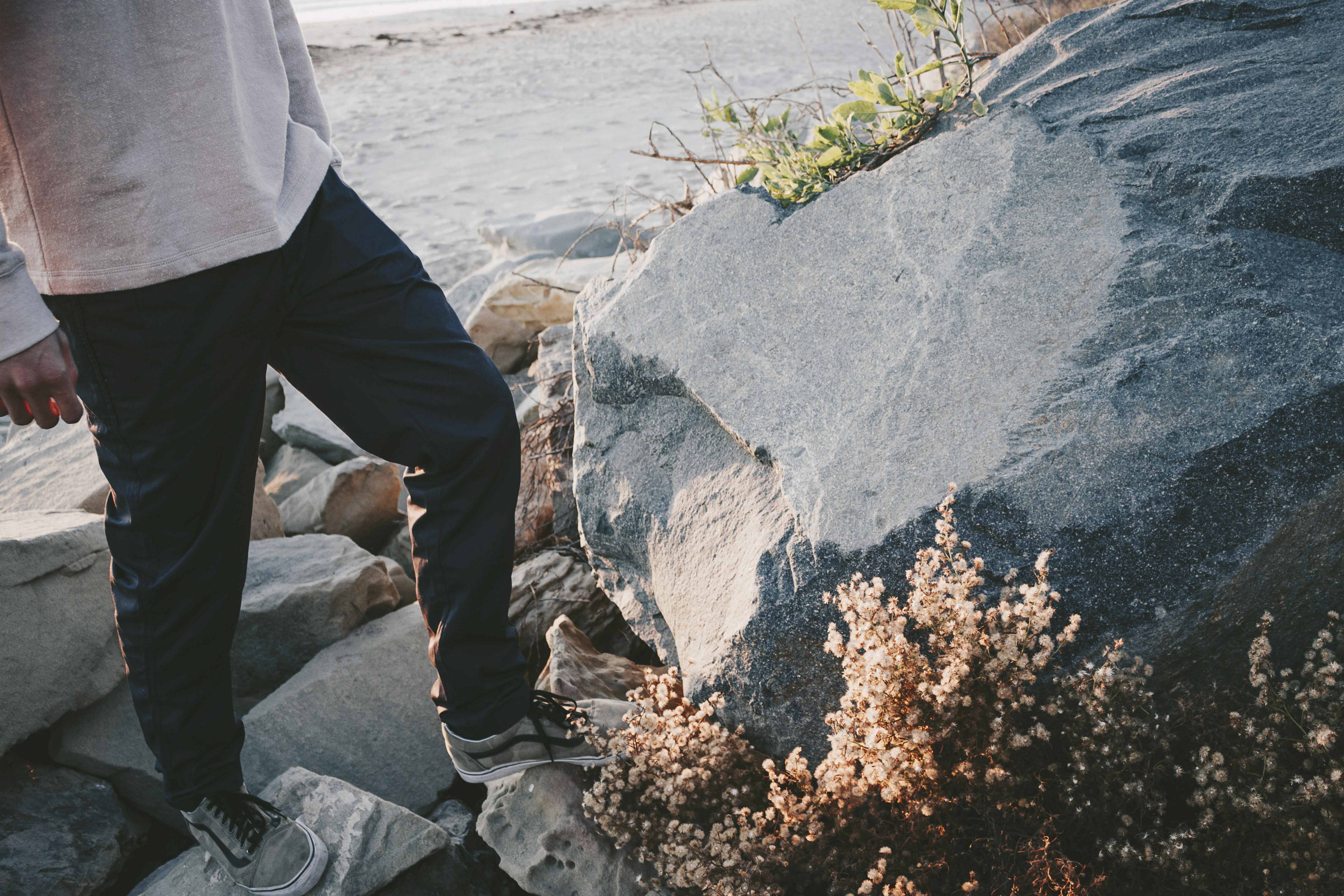 Iron & Resin Nomad Pant in Navy at the coast