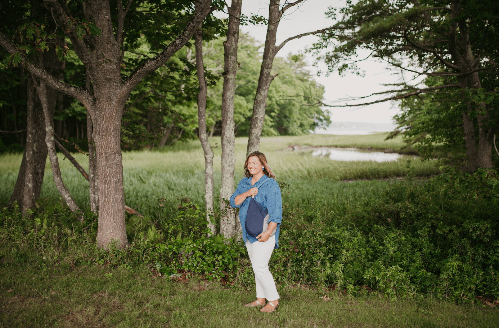 woman wearing a canvas bag near a marsh